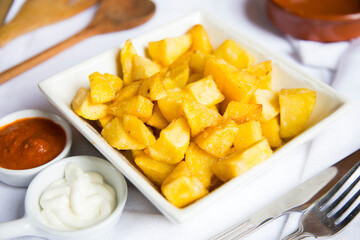 Papas bravas, are a typical preparation of bars in Spain consisting of potatoes cut into large cubes, fried in olive oil and seasoned with salsa brava, which is a spicy sauce.