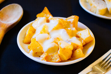 Papas bravas, are a typical preparation of bars in Spain consisting of potatoes cut into large cubes, fried in olive oil and seasoned with salsa brava, which is a spicy sauce.