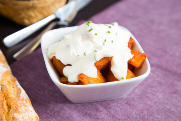 Papas bravas, are a typical preparation of bars in Spain consisting of potatoes cut into large cubes, fried in olive oil and seasoned with salsa brava, which is a spicy sauce.