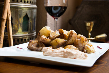 Papas bravas, are a typical preparation of bars in Spain consisting of potatoes cut into large cubes, fried in olive oil and seasoned with salsa brava, which is a spicy sauce.