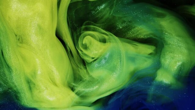 Green and orange ink flow with various textures and strong shadows