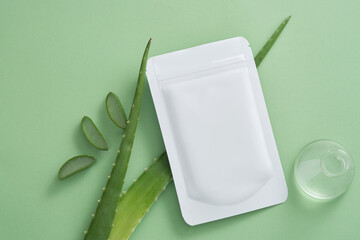 A mask sheet decorated with Aloe vera leaves and an erlenmeyer flask. Aloe vera (Aloe barbadensis...