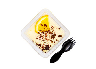 Dessert of white and brown cream with an orange slice in a plastic container on a white background.