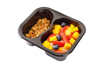 Dessert of cream, mango, strawberries and muesli on a white background.