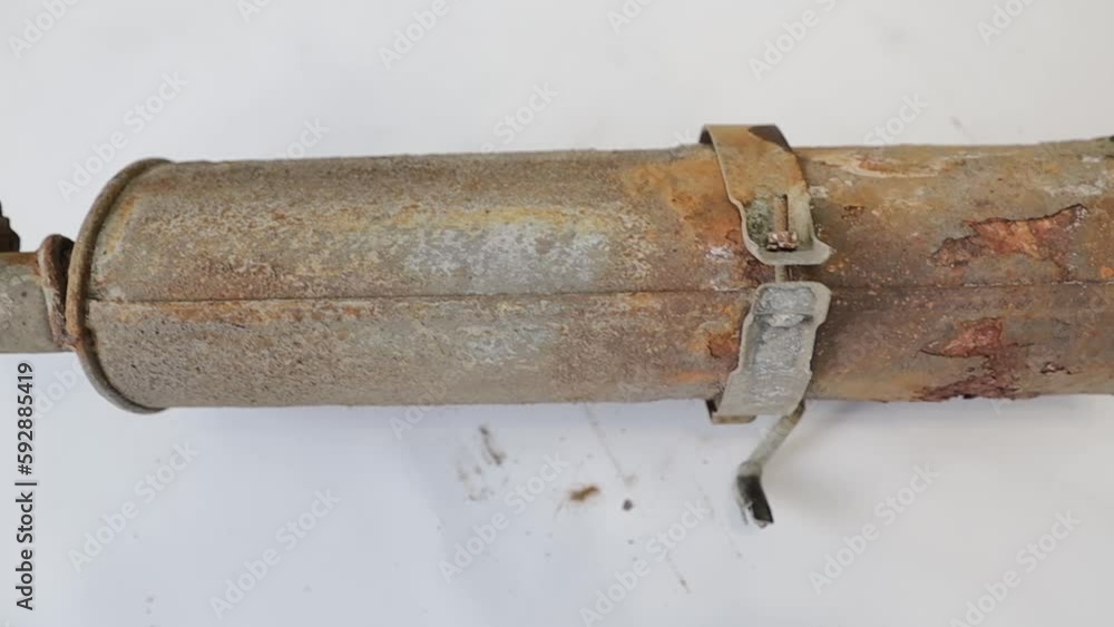 Poster old rusty car muffler close up