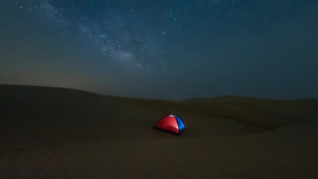 4K Time lapse of night sky milky way while camping in dark universe in desert.