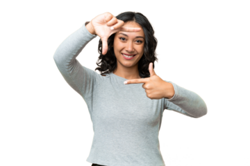 Young Argentinian woman over isolated background focusing face. Framing symbol