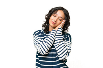 Young Argentinian woman over isolated background making sleep gesture in dorable expression