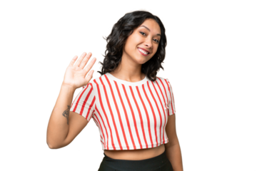 Young Argentinian woman over isolated background saluting with hand with happy expression