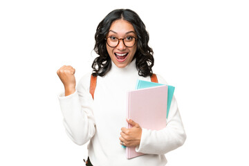 Young Argentinian student woman over isolated background celebrating a victory in winner position