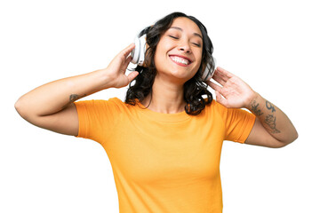 Young caucasian Argentinian woman over isolated background listening music and singing