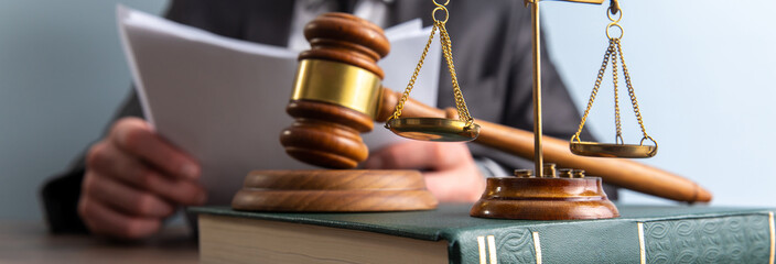  Business and lawyers discussing contract papers with brass scale on desk