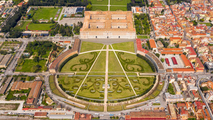 Aerial view of the Royal Palace of Caserta also known as Reggia di Caserta. It is a former royal residence with large gardens in Caserta, near Naples, Italy. The historic center of the city is nearby.