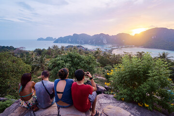 Traveling by Thailand. Friends enjoying wonderful sunset taking photo on Phi Phi Don island view point