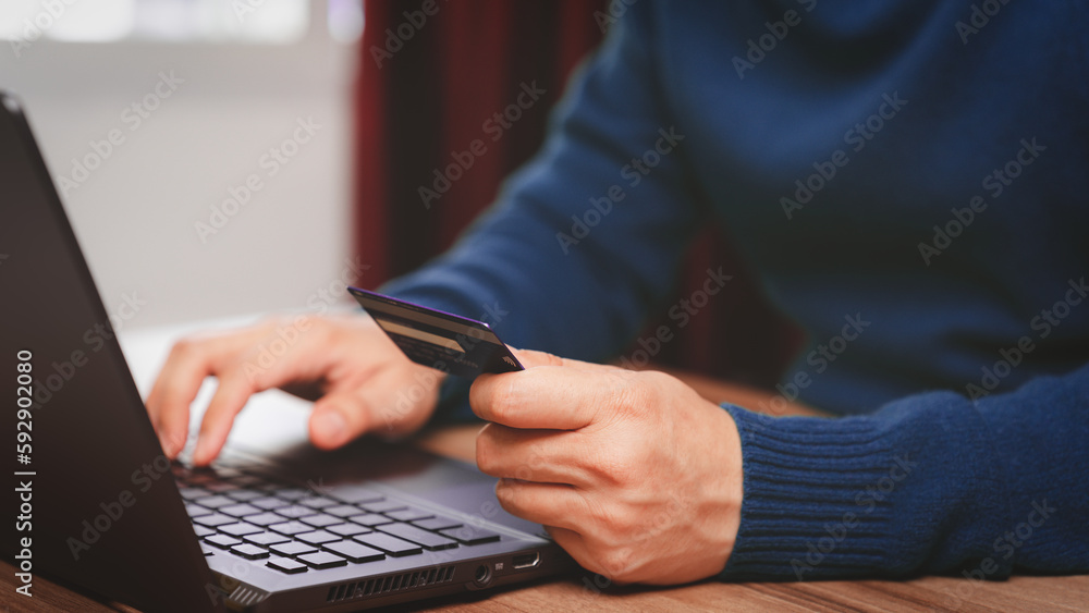 Poster young man using laptop to register via credit card to shop online. credit card secure online shoppin