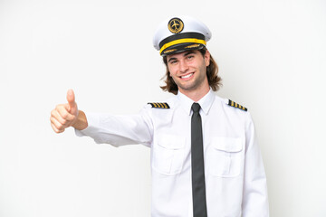 handsome Airplane pilot isolated on white background giving a thumbs up gesture