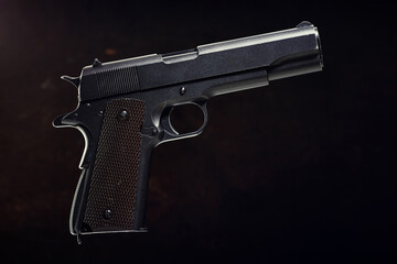 Colt 1911 pistol on the black background.