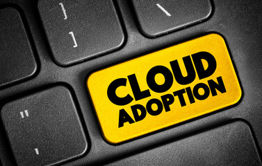 Fototapeta premium Cloud Adoption is a strategic move by organisations of reducing cost, mitigating risk and achieving scalability of data base capabilities, text concept on keyboard
