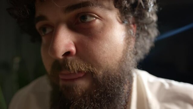 portrait of a drunken, bearded Caucasian man. Alcohol addiction in a young man. close-up 