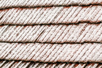 Closeup shot of a wooden roof covered with snow