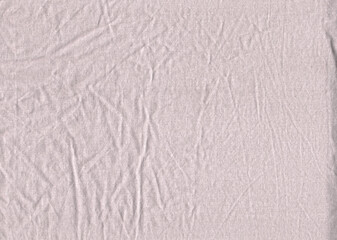 Gray tulle fabric with small wrinkled folds. Uniform surface of natural fabric fine dotted texture