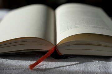 Open book on a white fabric background.