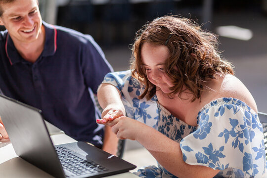 Happy young person with a disability using hands to talk in AUSLAN australian sign language
