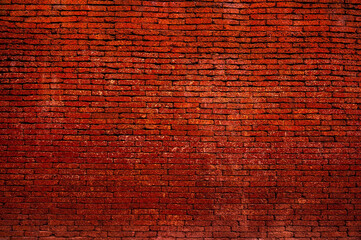 Background of old vintage dirty brick wall with Dark color, texture,reddish clayey material, hard when dry, forming topsoil in some tropical or subtropical regions and sometimes used for building