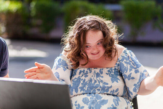 Happy seventeen year old girl with a disability doing a joyful dance move