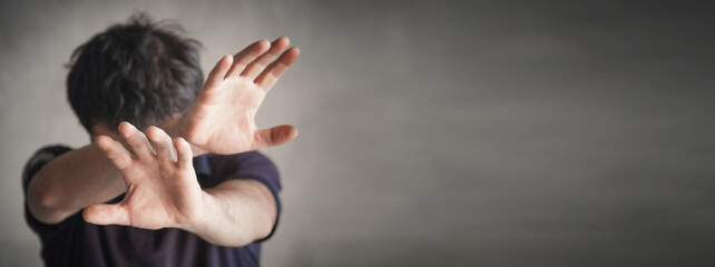 Caucasian man making stop gesture.