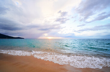 Fototapeta na wymiar Seascape with sunset on the ocean shore. Beautiful cloudy sky.