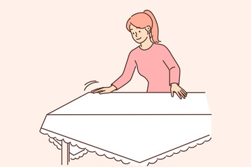Woman housewife sets table with white tablecloth preparing for festive dinner or lunch with family