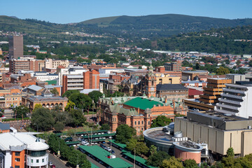 Fototapeta na wymiar A mid view of the city hall and buildings in downtown Pietermaritzburg, Kwazulu-Natal, with suburbs and hills in the background.