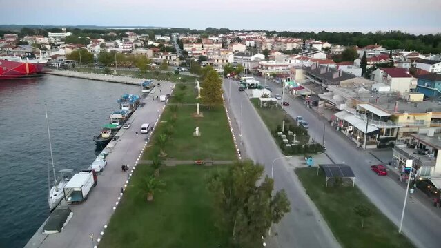 Aerial footage over the town of Keramoti and people walking near the sea