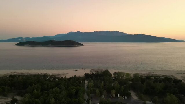Aerial view of a Keramoti town with buildings and sea at scenic sunset in Greece