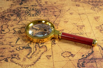 Fototapeta na wymiar Magnifier put on the map - concept of adventures and traveling