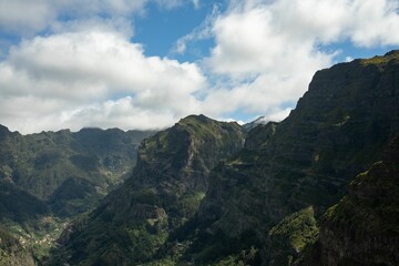 Fototapeta na wymiar Aerial view of mountains in Madeira Island with a cloudy sky in the background, Portugal