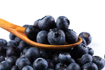 Fresh blueberries in wooden spoon
