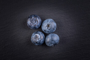 Blueberries on stone plate background