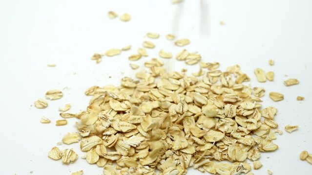 Falling Oat Flakes Rotated On White Background.