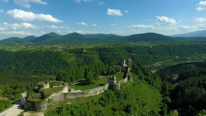 Aerial view of an old castle in a mountainous landscape