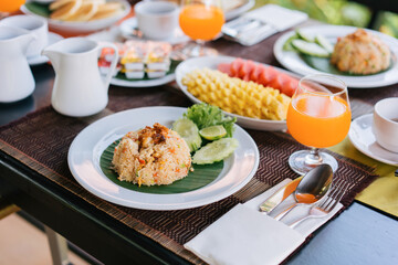 Thai food, breakfast with American food, khao Phad on old wooden table