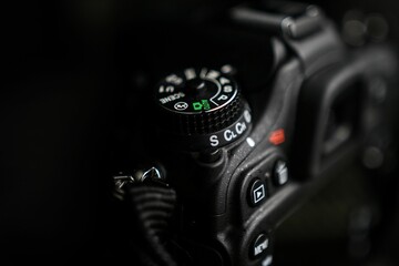 Closeup shot of details on a modern black DSLR camera dial