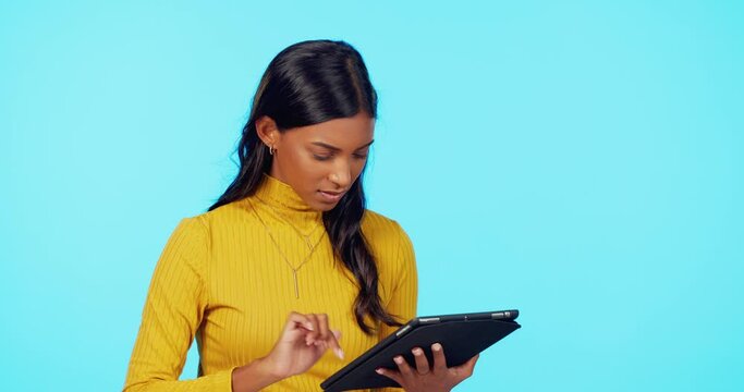 Tablet, glitch and frustrated woman in a studio with scam email and angry from typing. Isolated, blue background and young person with 404 tech problem and spam information online with digital issue