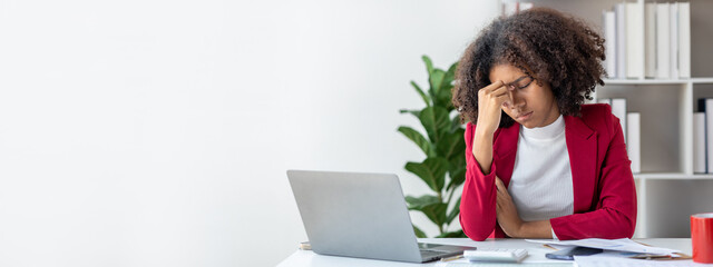 American woman is start-up businesswoman, she sits in the office and suffers from the stress of...