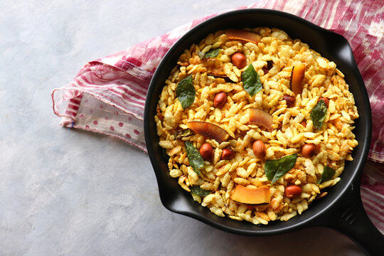 Jada Poha Namkeen Chivda or Thick Pohe Chiwda. Diwali special savory snack, made out of puffed rice, fried peanuts, curry leaves and some spices. Traditional Indian Diwali Snacks. with Copy Space.