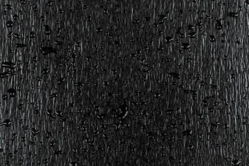 Water drops on dark stone