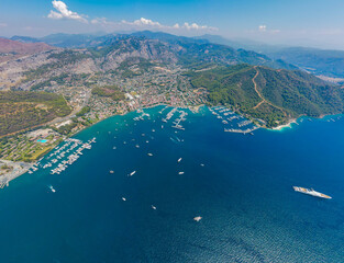 Aerial drone photo of the bustling Göcek Marina, located in the beautiful coastal town of Muğla, Turkey, captured by a drone showcasing the vibrant harbor and surrounding landscape.