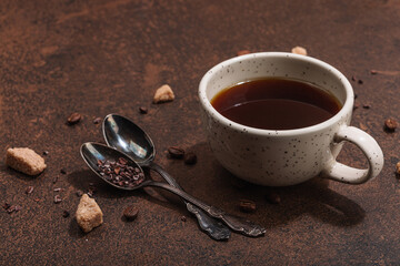Cup of coffee in dark tones. Morning good mood, breakfast concept. Brown sugar, cutlery