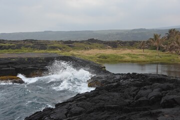 Waves crashing onto the rocks on the beach